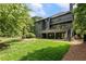 Stunning backyard showcasing a lush green lawn, multi-level deck, dark exterior paint and mature landscaping at 320 Shady Grove Ln, Alpharetta, GA 30009