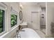 Bright bathroom featuring a soaking tub, glass-enclosed shower, and a large window at 320 Shady Grove Ln, Alpharetta, GA 30009