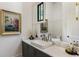 Elegant bathroom with marble countertop, decorative mirror and sink at 320 Shady Grove Ln, Alpharetta, GA 30009