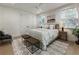 Well-lit bedroom with a large bed, sitting area, hardwood floors, and lots of natural light at 320 Shady Grove Ln, Alpharetta, GA 30009
