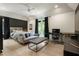 Large bedroom with a decorative accent wall, comfortable seating area, and a desk area at 320 Shady Grove Ln, Alpharetta, GA 30009