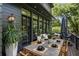 Outdoor patio with a dining table, comfortable seating area, and lush greenery for outdoor living at 320 Shady Grove Ln, Alpharetta, GA 30009