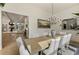 Elegant dining room features a large table, chandelier, and open access to the kitchen at 320 Shady Grove Ln, Alpharetta, GA 30009