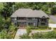 Stately two-story home with a manicured front yard and gray exterior, surrounded by mature trees at 320 Shady Grove Ln, Alpharetta, GA 30009