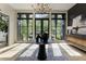 Bright foyer featuring statement lighting, a decorative table, and a view of the landscaped outdoors at 320 Shady Grove Ln, Alpharetta, GA 30009