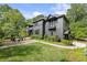 Charming home with lush landscaping, a stone walkway, and a cozy fire pit area in the front yard at 320 Shady Grove Ln, Alpharetta, GA 30009