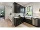 Spacious kitchen has dark cabinets, a farmhouse sink, marble counters, stainless dishwasher, and hardwood flooring at 320 Shady Grove Ln, Alpharetta, GA 30009