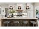 Elegant kitchen featuring a marble island with seating, custom cabinetry, and stylish lighting at 320 Shady Grove Ln, Alpharetta, GA 30009