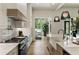Bright kitchen features stone countertops, stainless steel appliances, and hardwood flooring at 320 Shady Grove Ln, Alpharetta, GA 30009
