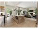Open concept kitchen and living room features a large island, modern appliances, and a cozy fireplace at 320 Shady Grove Ln, Alpharetta, GA 30009