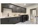 Well-appointed laundry room with modern appliances, cabinets, and countertop space at 320 Shady Grove Ln, Alpharetta, GA 30009