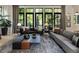 Open living room with large windows offering scenic views, comfortable sofas, and stylish accents at 320 Shady Grove Ln, Alpharetta, GA 30009