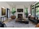 Cozy living room featuring a fireplace, large windows, and contemporary decor at 320 Shady Grove Ln, Alpharetta, GA 30009