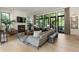 Sunlit living room boasts a fireplace, hardwood floors, and large windows with backyard views at 320 Shady Grove Ln, Alpharetta, GA 30009