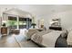 Bright main bedroom with vaulted ceiling, seating area, and balcony access at 320 Shady Grove Ln, Alpharetta, GA 30009