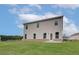 Spacious backyard with lush lawn and tan siding on a modern two-story home at 320 Tulip Dr, Covington, GA 30016