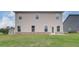 Two-story home with a backyard featuring a lush green lawn and neutral siding at 320 Tulip Dr, Covington, GA 30016