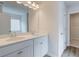 Bathroom with dual vanity, quartz counters, and access to closet at 320 Tulip Dr, Covington, GA 30016