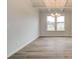 Elegant dining area with gorgeous floors, a modern light fixture, and a large window overlooking the outdoors at 320 Tulip Dr, Covington, GA 30016