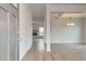 Bright entryway with light wood floors, a coffered ceiling, and a view of the fireplace in the living room at 320 Tulip Dr, Covington, GA 30016