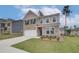 Beautiful two-story home with a brick and siding facade, lush green lawn, and a double garage at 320 Tulip Dr, Covington, GA 30016