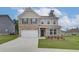 Charming two-story home featuring a brick facade, neutral siding, and an attached two-car garage at 320 Tulip Dr, Covington, GA 30016
