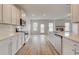 A modern kitchen with white cabinets and stainless steel appliances opening up to the living room at 320 Tulip Dr, Covington, GA 30016