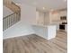 Contemporary kitchen with white cabinets, stainless steel appliances, and a quartz countertop island at 320 Tulip Dr, Covington, GA 30016