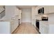 Modern kitchen with stainless steel appliances, quartz countertops, and new hardwood flooring at 320 Tulip Dr, Covington, GA 30016
