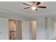 Open-concept living room with fan, and access to other rooms at 320 Tulip Dr, Covington, GA 30016