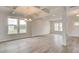 Expansive living room featuring stylish wood floors, large windows, recessed lighting, and a coffered ceiling at 320 Tulip Dr, Covington, GA 30016