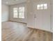 Cozy living room showcasing stylish wood-look floors and lots of natural light through the large windows at 320 Tulip Dr, Covington, GA 30016
