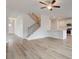 Bright living room featuring an open floor plan, hardwood floors, and a stylish staircase at 320 Tulip Dr, Covington, GA 30016