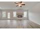 Spacious living room with modern fireplace, hardwood floors, and natural light from large windows at 320 Tulip Dr, Covington, GA 30016