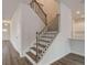 Elegant staircase featuring wood steps, metal railing, and access to multiple levels of the home at 320 Tulip Dr, Covington, GA 30016
