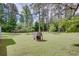 Expansive backyard with brick grill, green grass, and mature trees at 4700 Cascade Sw Rd, Atlanta, GA 30331