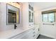 Bright bathroom features a double sink vanity, quartz countertop and modern fixtures at 4700 Cascade Sw Rd, Atlanta, GA 30331