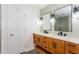 Modern bathroom featuring double vanity with wood cabinets, and decorative mirrors at 4700 Cascade Sw Rd, Atlanta, GA 30331