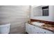 Bathroom with neutral walls, white cabinets, and brown marbled countertops at 4700 Cascade Sw Rd, Atlanta, GA 30331