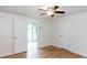 Bright bedroom featuring neutral walls, wood floors, and closet for ample storage at 4700 Cascade Sw Rd, Atlanta, GA 30331
