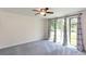 Bright bedroom featuring neutral walls, plush carpeting, and door leading outside at 4700 Cascade Sw Rd, Atlanta, GA 30331