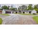 Striking renovated home with a large manicured lawn, contrasting black trim, and an expansive circular driveway at 4700 Cascade Sw Rd, Atlanta, GA 30331