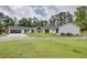 Stunning white brick home featuring a modern design, lush lawn, and a spacious driveway leading to an attached garage at 4700 Cascade Sw Rd, Atlanta, GA 30331