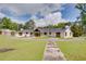 Attractive exterior featuring a well-maintained lawn, a white painted brick home, and ample greenery at 4700 Cascade Sw Rd, Atlanta, GA 30331