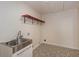 A convenient laundry room that features stainless steel sink and stylish flooring at 4700 Cascade Sw Rd, Atlanta, GA 30331