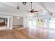 Open concept living room with hardwood floors, fan, large windows, and a dining nook at 4700 Cascade Sw Rd, Atlanta, GA 30331