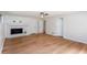 Bright living room with hardwood floors, ceiling fan, and fireplace with white tile surround at 4700 Cascade Sw Rd, Atlanta, GA 30331
