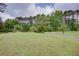 Lush green property with mature trees, decorative fencing, and a winding driveway leading to a secluded residence at 4700 Cascade Sw Rd, Atlanta, GA 30331
