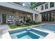 Luxury outdoor living area with a large pool, lounge chairs, and a full outdoor kitchen at 4785 Merlendale Ct, Atlanta, GA 30327