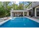 Stunning backyard featuring a large pool, outdoor kitchen and covered patio area at 4785 Merlendale Ct, Atlanta, GA 30327